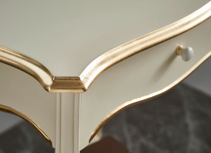 Telefontisch mit goldfarbenen Applikationen 